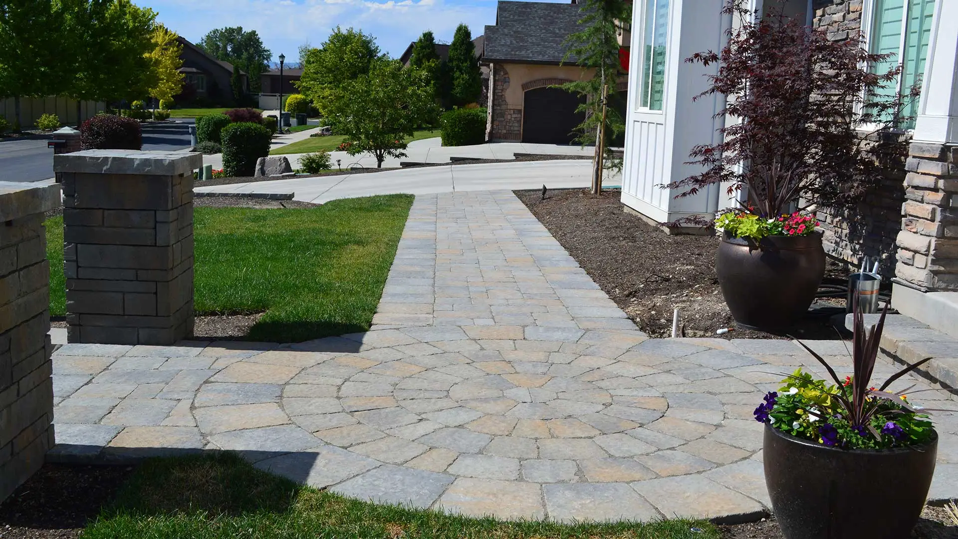 A new patio and walkway recently designed and installed by our professionals at a home in South Jordan. 