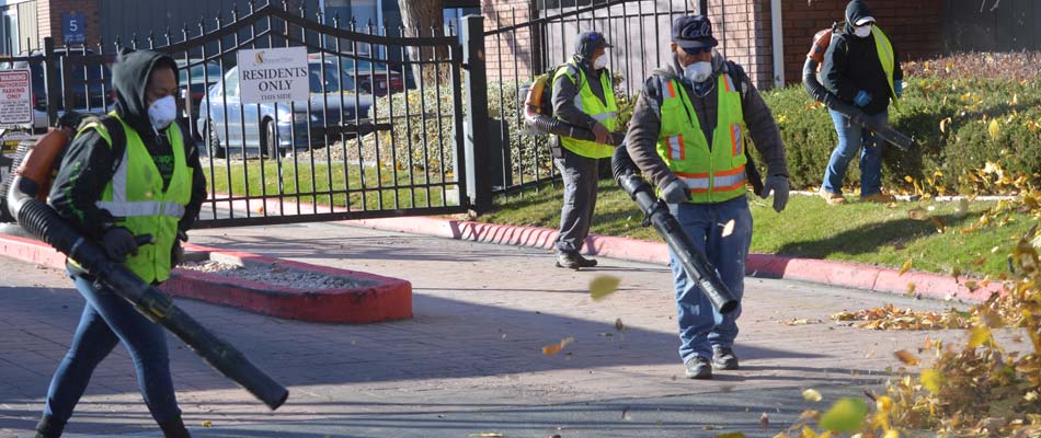 Our team blowing leaves and yard debris after yard services at a commercial property in Salt Lake City.