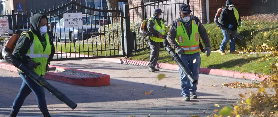 Our team blowing leaves and yard debris after yard services at a commercial property in Salt Lake City.