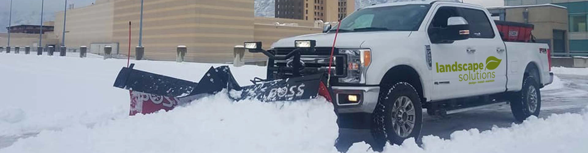 Our snow plow clearing a commercial parking lot in Salt Lake City.